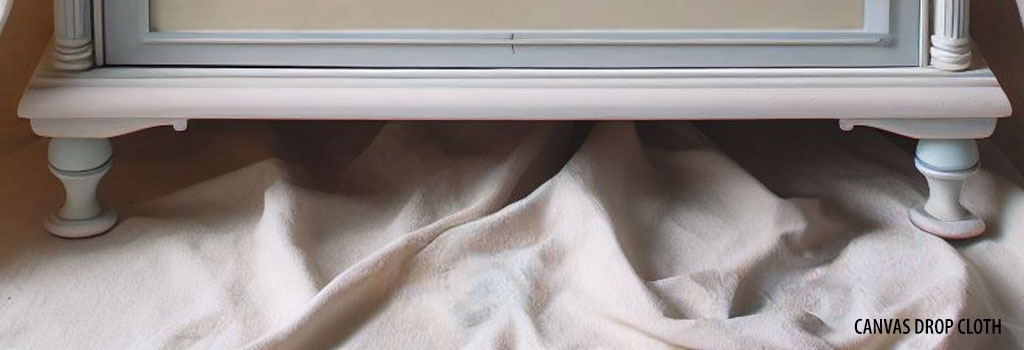 Protecting floor from paint with a drop cloth.